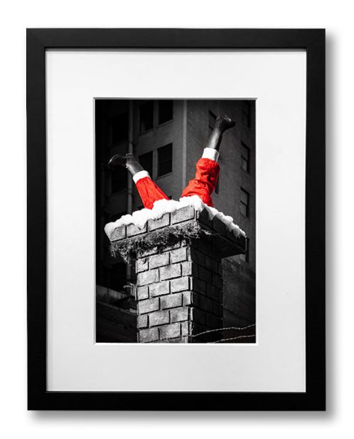 Framed black and white photograph with splash of red for Santa's trousers