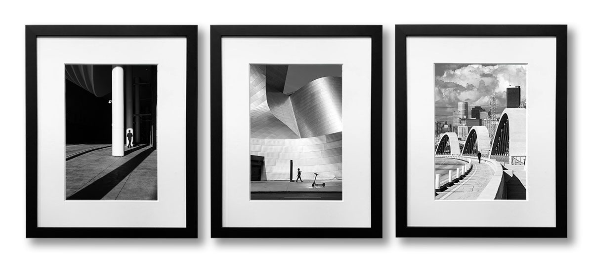 Three framed black and white photographs of Los Angeles.
