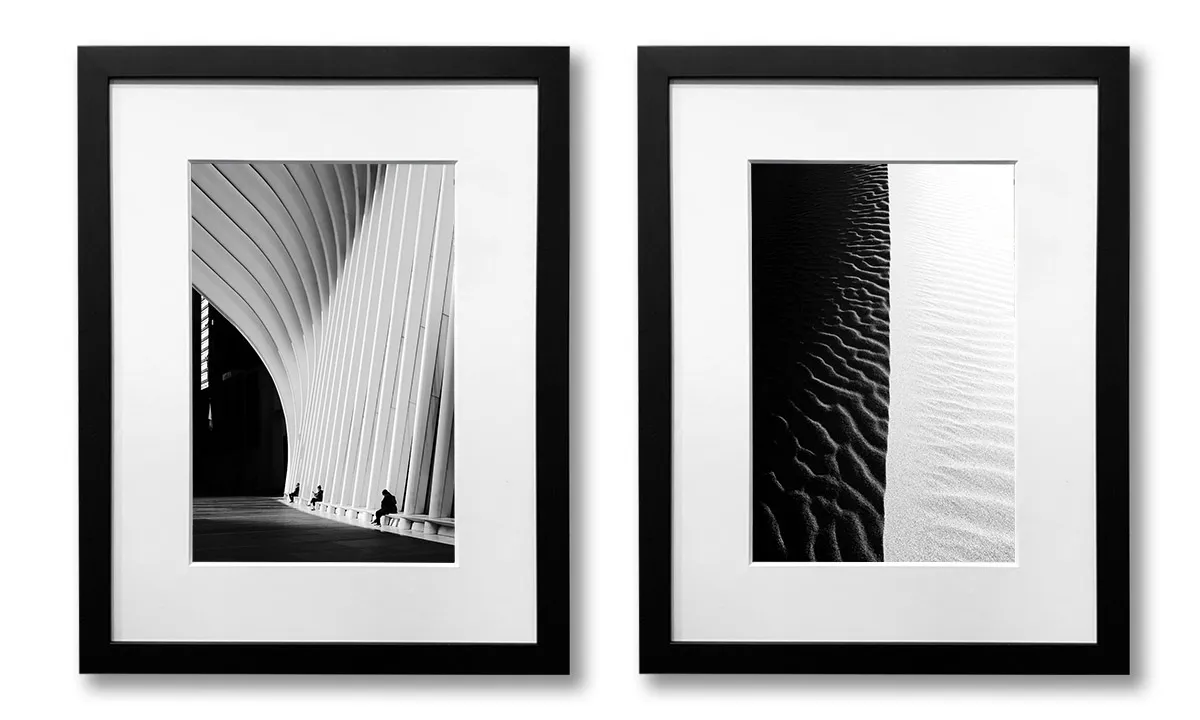 Framed black and white photographs of the Oculus in New York City and Death Valley dunes